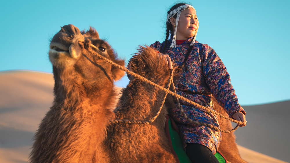 Woman riding camel
